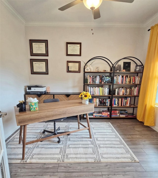 office space with ceiling fan, ornamental molding, and wood finished floors