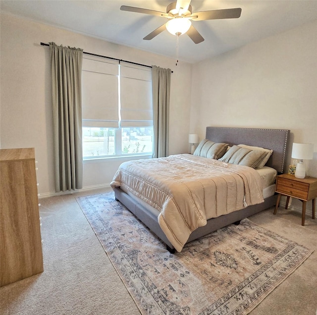 carpeted bedroom featuring a ceiling fan and baseboards