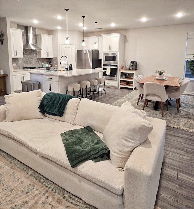 living area with wood finished floors and recessed lighting