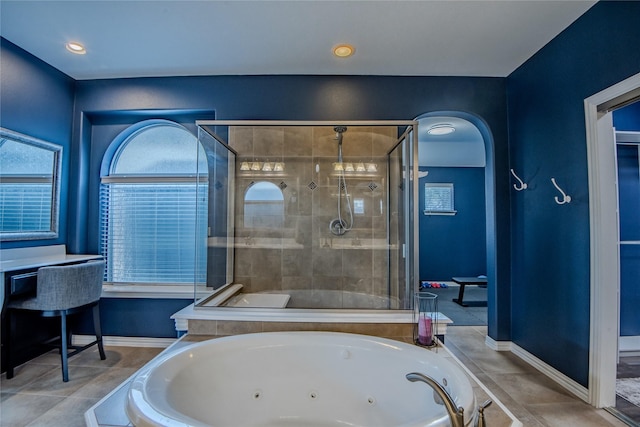 full bathroom featuring a shower stall and a jetted tub