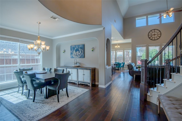 dining area with stairway, visible vents, arched walkways, dark wood-style flooring, and a wealth of natural light