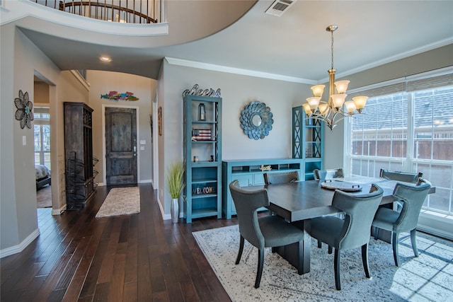 dining room featuring visible vents, dark wood-type flooring, a chandelier, and crown molding