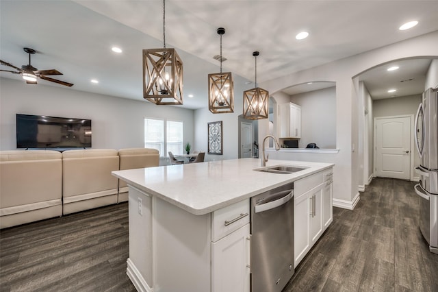1121 Ash St, Celina, TX 75009 - kitchen featuring arched walkways, stainless steel appliances, a sink, open floor plan, and an island with sink