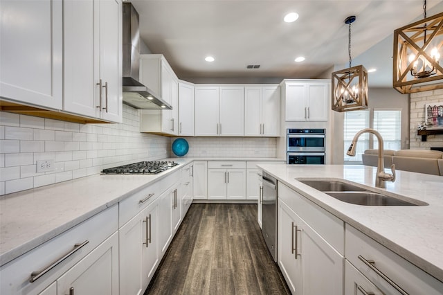 1121 Ash St, Celina, TX 75009 - kitchen featuring stainless steel appliances, dark wood-type flooring, white cabinets, a sink, and wall chimney exhaust hood