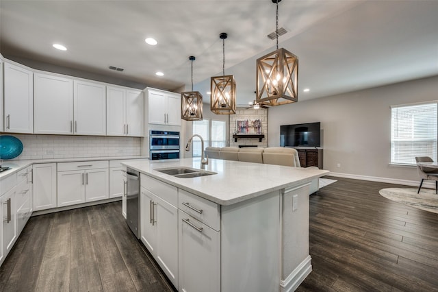 1121 Ash St, Celina, TX 75009 - kitchen featuring dark wood-style flooring, a sink, visible vents, appliances with stainless steel finishes, and tasteful backsplash