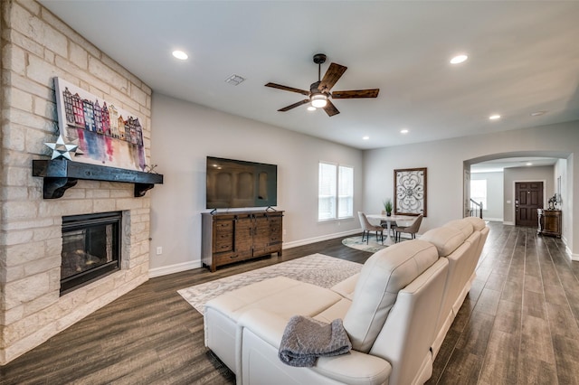 1121 Ash St, Celina, TX 75009 - living room with visible vents, arched walkways, dark wood finished floors, a fireplace, and recessed lighting