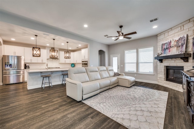 1121 Ash St, Celina, TX 75009 - living area featuring ceiling fan, recessed lighting, a fireplace, visible vents, and dark wood finished floors