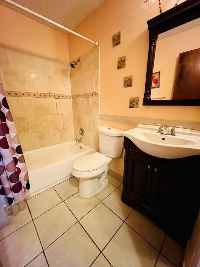 full bathroom with shower / tub combo with curtain, vanity, toilet, and tile patterned floors