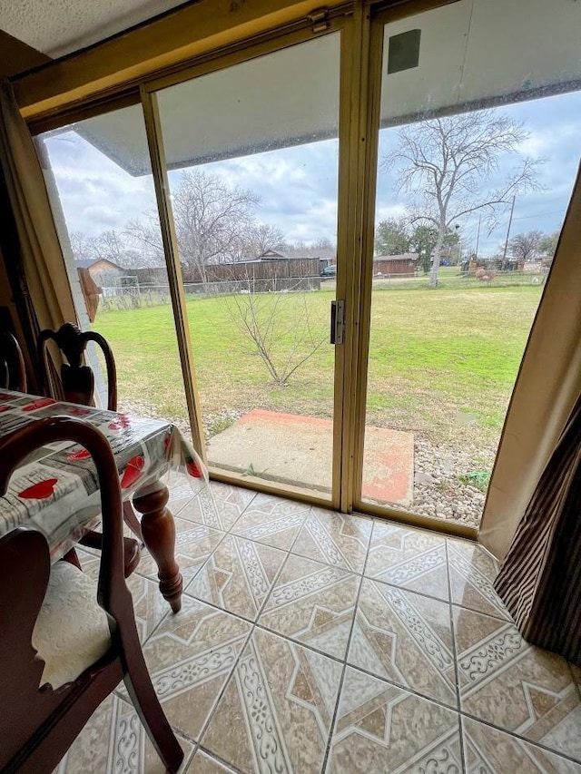 doorway to outside with tile patterned flooring