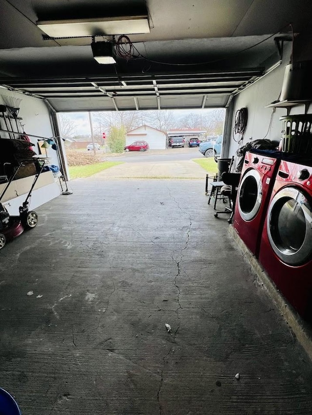 garage with a garage door opener and separate washer and dryer