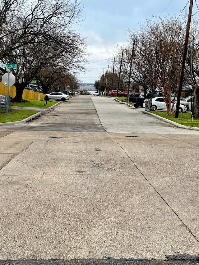 view of street with curbs and traffic signs