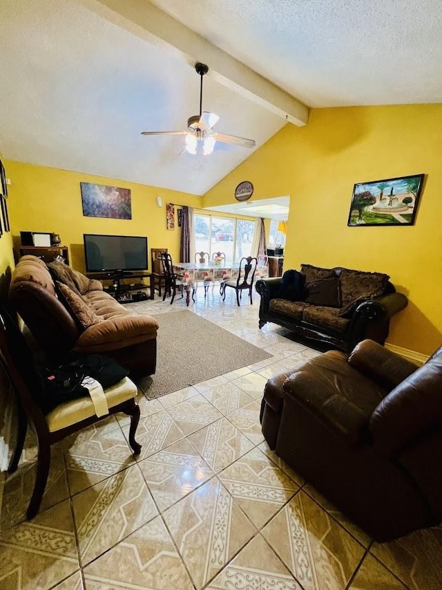 living area featuring a textured ceiling, light tile patterned floors, a ceiling fan, and vaulted ceiling with beams