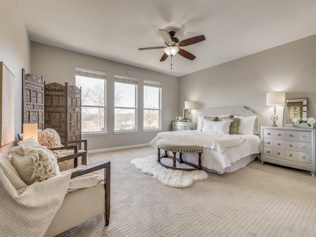 bedroom with light carpet, a ceiling fan, and baseboards