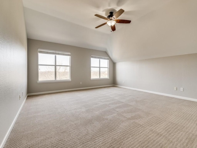 additional living space with lofted ceiling, carpet, baseboards, and a ceiling fan