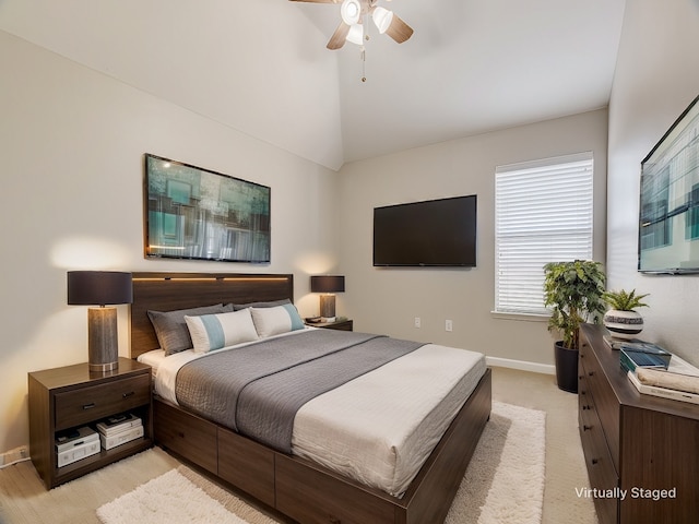 bedroom featuring lofted ceiling, baseboards, and a ceiling fan