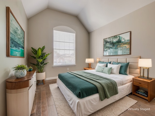 bedroom featuring lofted ceiling and wood finished floors