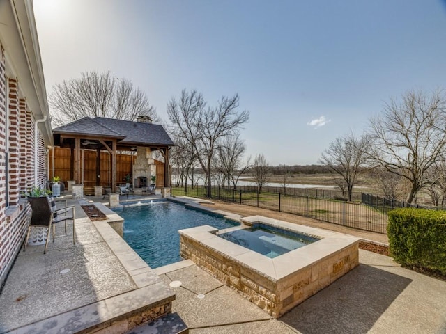 view of pool featuring a patio, an outdoor fireplace, a fenced backyard, an in ground hot tub, and a fenced in pool