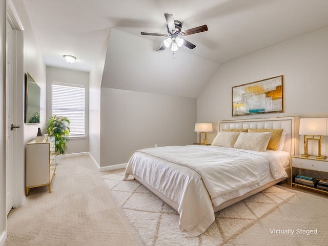 bedroom with lofted ceiling, carpet flooring, a ceiling fan, and baseboards