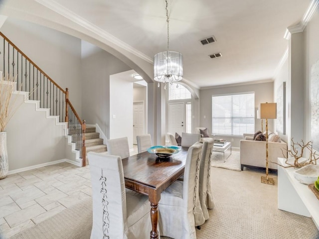 dining room with baseboards, stairs, and visible vents