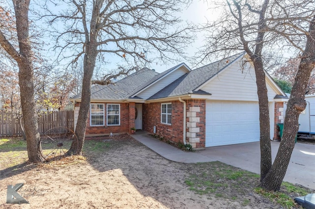 single story home with driveway, a garage, a shingled roof, fence, and brick siding