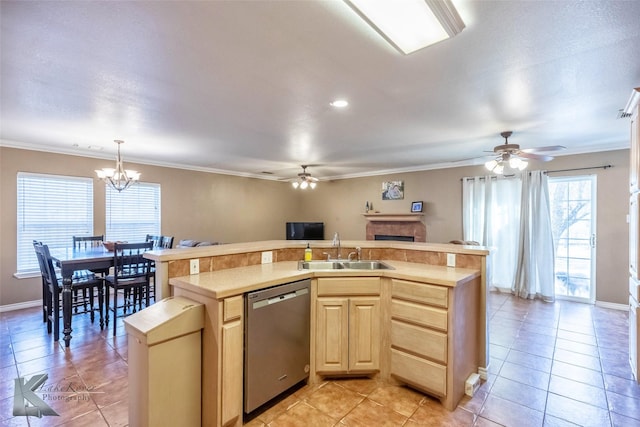 kitchen with dishwasher, light countertops, light brown cabinetry, a sink, and ceiling fan with notable chandelier