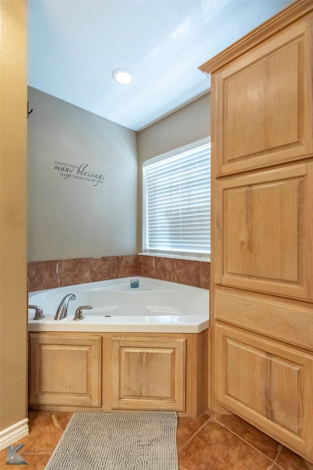 full bathroom with tile patterned flooring and a bath