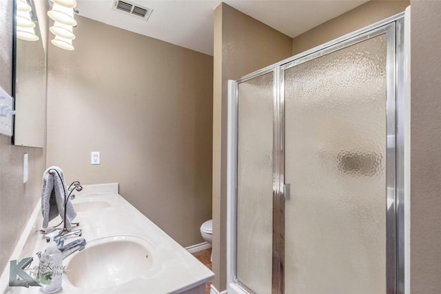 full bathroom with a stall shower, a sink, and visible vents