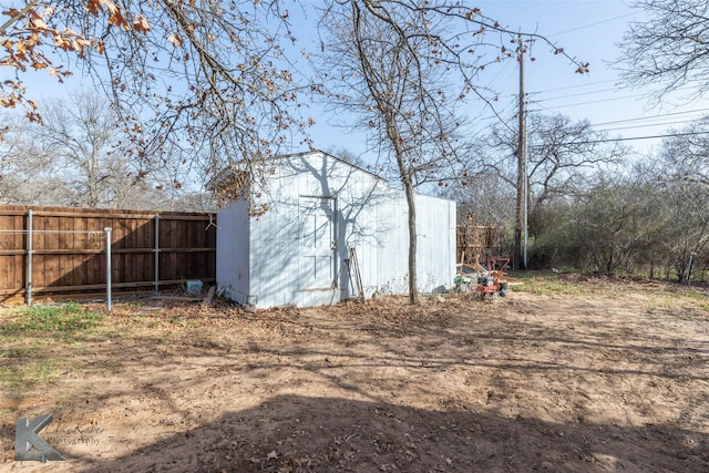 view of shed featuring fence