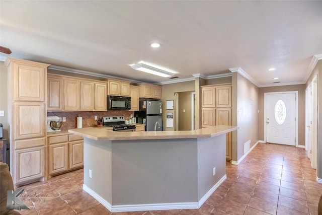 kitchen with light countertops, appliances with stainless steel finishes, light brown cabinetry, and tasteful backsplash