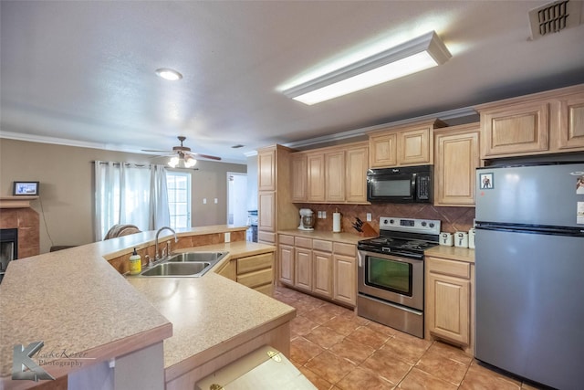 kitchen featuring light brown cabinets, appliances with stainless steel finishes, a sink, and visible vents