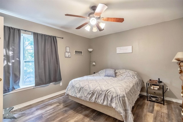 bedroom with wood finished floors, a ceiling fan, and baseboards