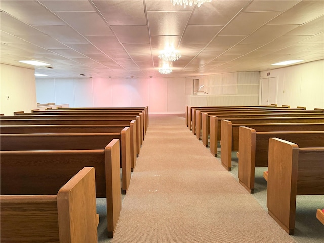 misc room featuring carpet and a decorative wall