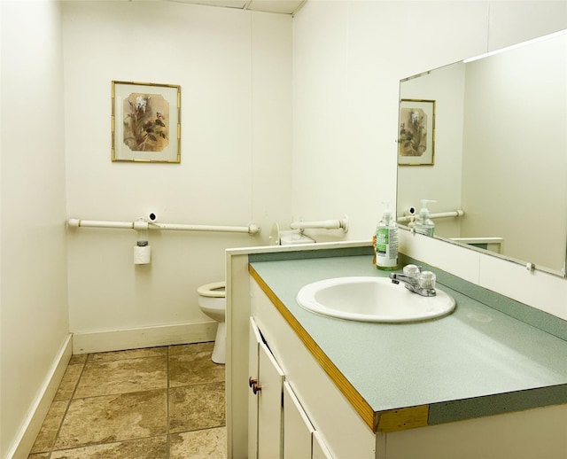 half bathroom with toilet, baseboards, and vanity