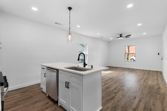 kitchen featuring pendant lighting, visible vents, stainless steel dishwasher, dark wood-type flooring, and a sink
