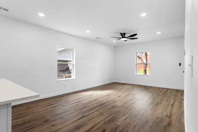unfurnished room with ceiling fan, wood finished floors, visible vents, and recessed lighting