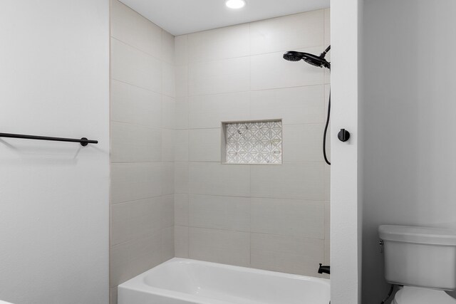 bathroom with toilet and  shower combination