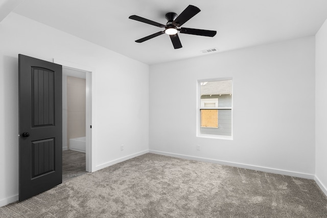 spare room with a ceiling fan, baseboards, visible vents, and carpet flooring