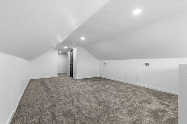 bonus room with lofted ceiling, visible vents, and baseboards