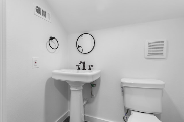 bathroom with visible vents and toilet