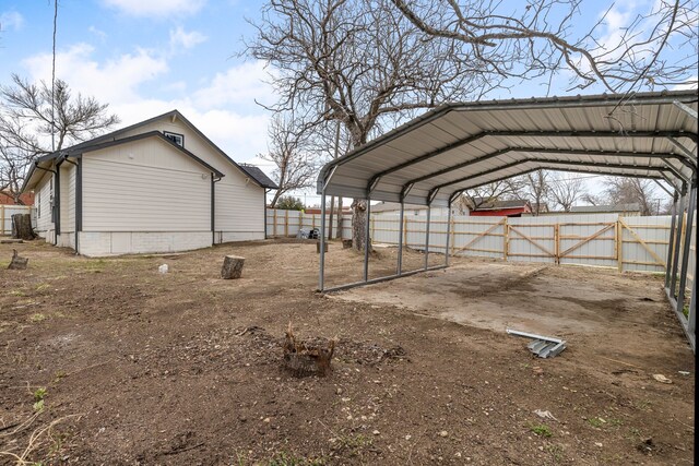 exterior space with a carport and fence