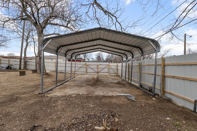 view of parking featuring a carport and fence