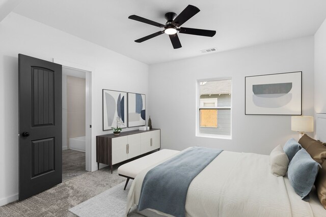 carpeted bedroom featuring visible vents and a ceiling fan