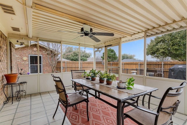 sunroom / solarium with visible vents and a ceiling fan