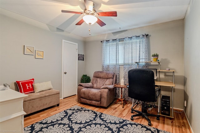 home office featuring light wood-style floors and a ceiling fan