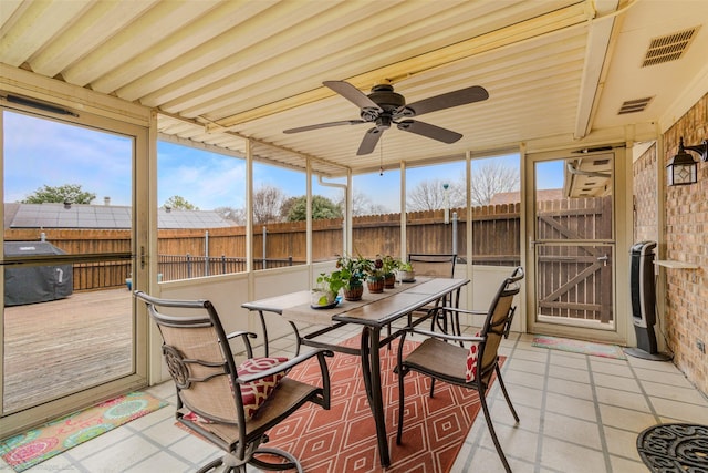 sunroom / solarium with visible vents and a ceiling fan