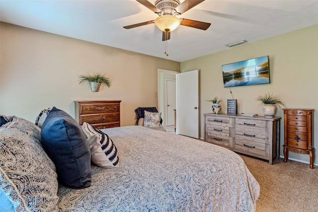 carpeted bedroom with ceiling fan, visible vents, and baseboards