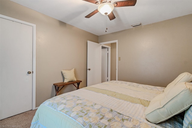 carpeted bedroom featuring visible vents and a ceiling fan