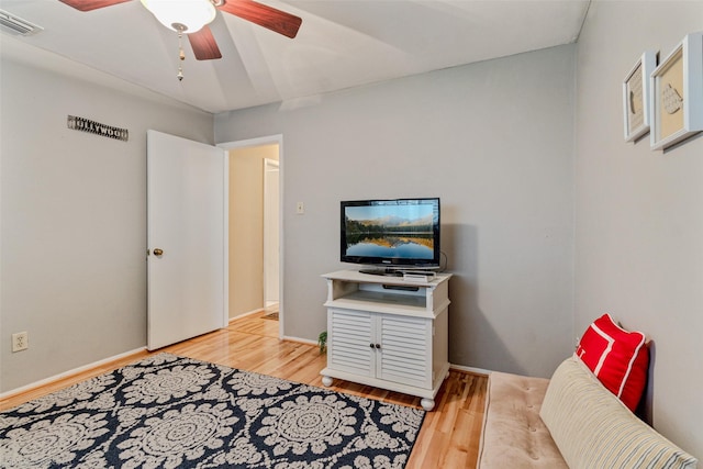 bedroom with light wood-type flooring, ceiling fan, visible vents, and baseboards