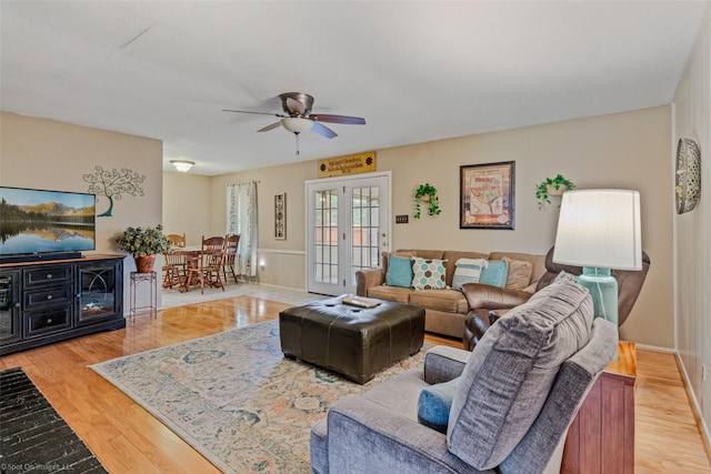 living room featuring ceiling fan, wood finished floors, and french doors