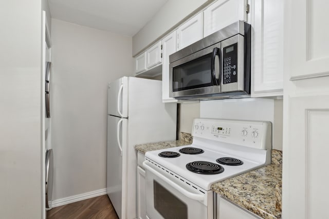 kitchen featuring stainless steel microwave, white cabinetry, dark wood-type flooring, and white range with electric stovetop